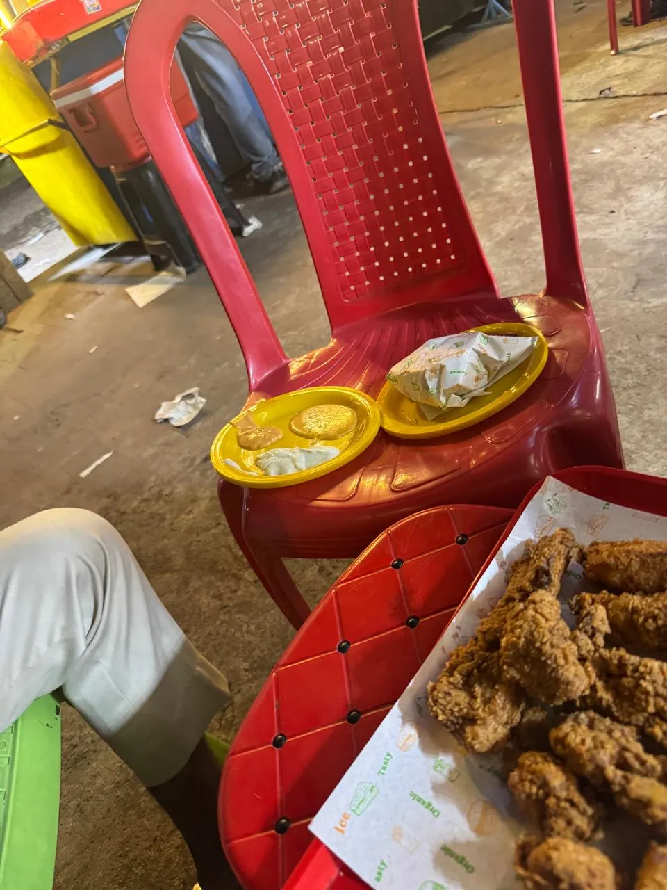 Broast chicken served on a tray at the stall's red chairs